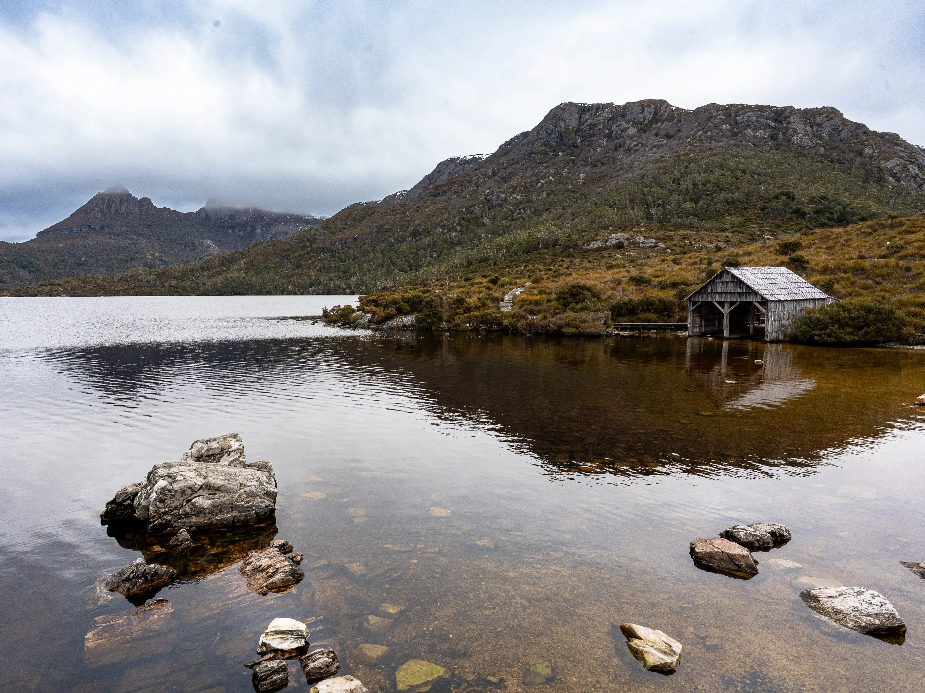Cradle Mountain and Dove Lake reflected in calm water in Tasmania, Australia.